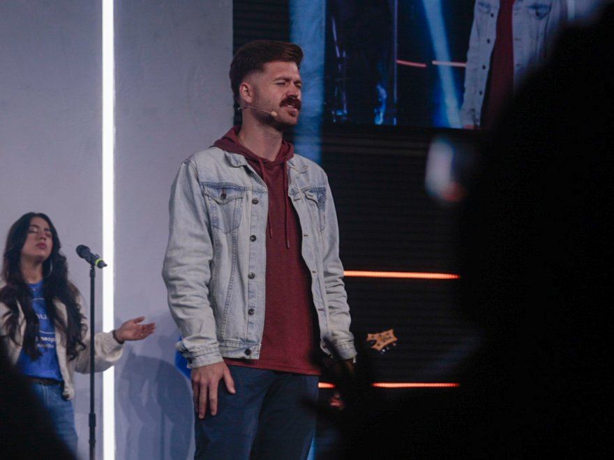 Worship leader singing on stage
